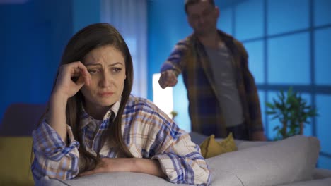 Unhappy-woman-crying,-having-problems-in-their-marriage,-in-the-background-her-husband-is-upset.